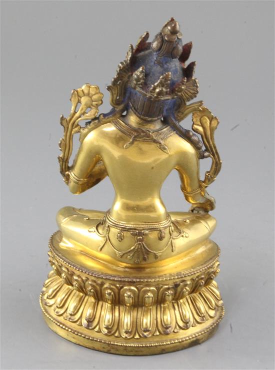 A Tibetan gilt bronze seated figure of Green Tara, height 21.5cm